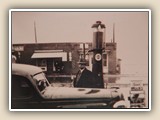 Dr. W.W. Washam was town doctor for 50+ years. Shown here at Lee Proctor's Esso station, across Main Street from Brick Row (1933). 